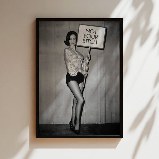 a black and white photo of a woman holding a sign