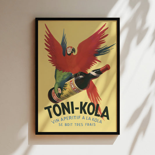 The image is a framed vintage advertisement poster for toni-kola. It features a parrot flying over a bottle of toni-kola, with the text "VIN APERTIF A LA KOLA" and "SE BOIT TRES FRAIS" prominently displayed.