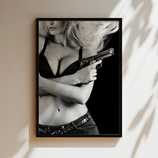 a black and white photo of a woman holding a gun