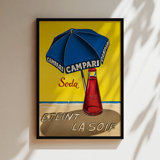 The image is a framed vintage advertisement for Campari soda, featuring a blue umbrella and a red bottle on a beach background.