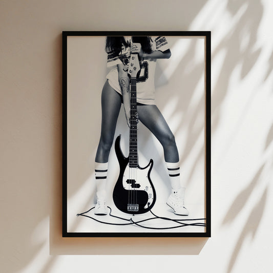 a black and white photo of a woman with a guitar