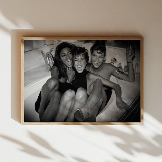 a black and white photo of three women hanging on a wall