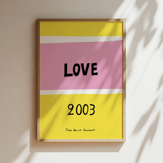 The image is a framed poster with a pink and yellow background, displaying the word "LOVE" in bold black letters. Below the word, the year "2003" is written in black.