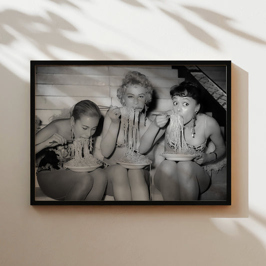 a black and white photo of a woman holding a baby