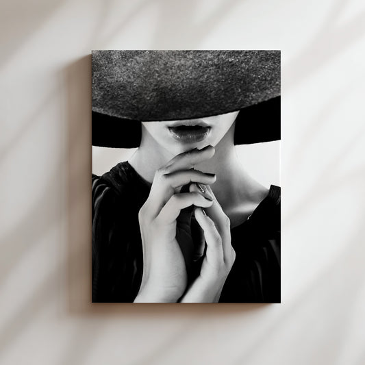 a black and white photo of a woman wearing a hat