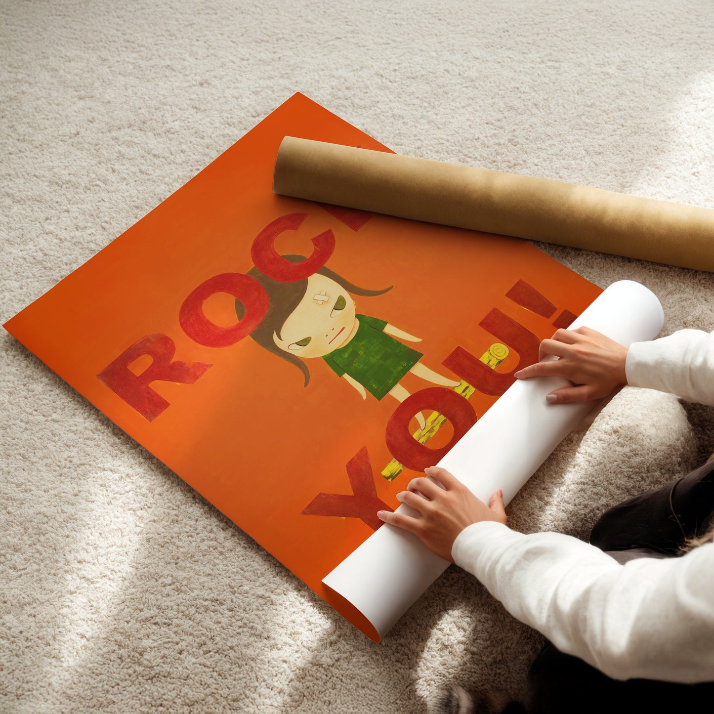 a child is holding a roll of paper on the floor