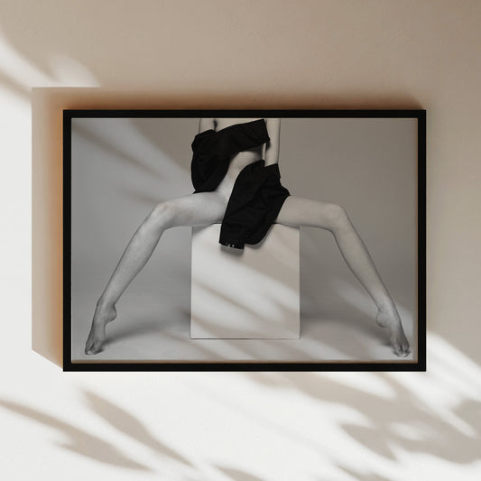 a black and white photo of a woman in a black dress