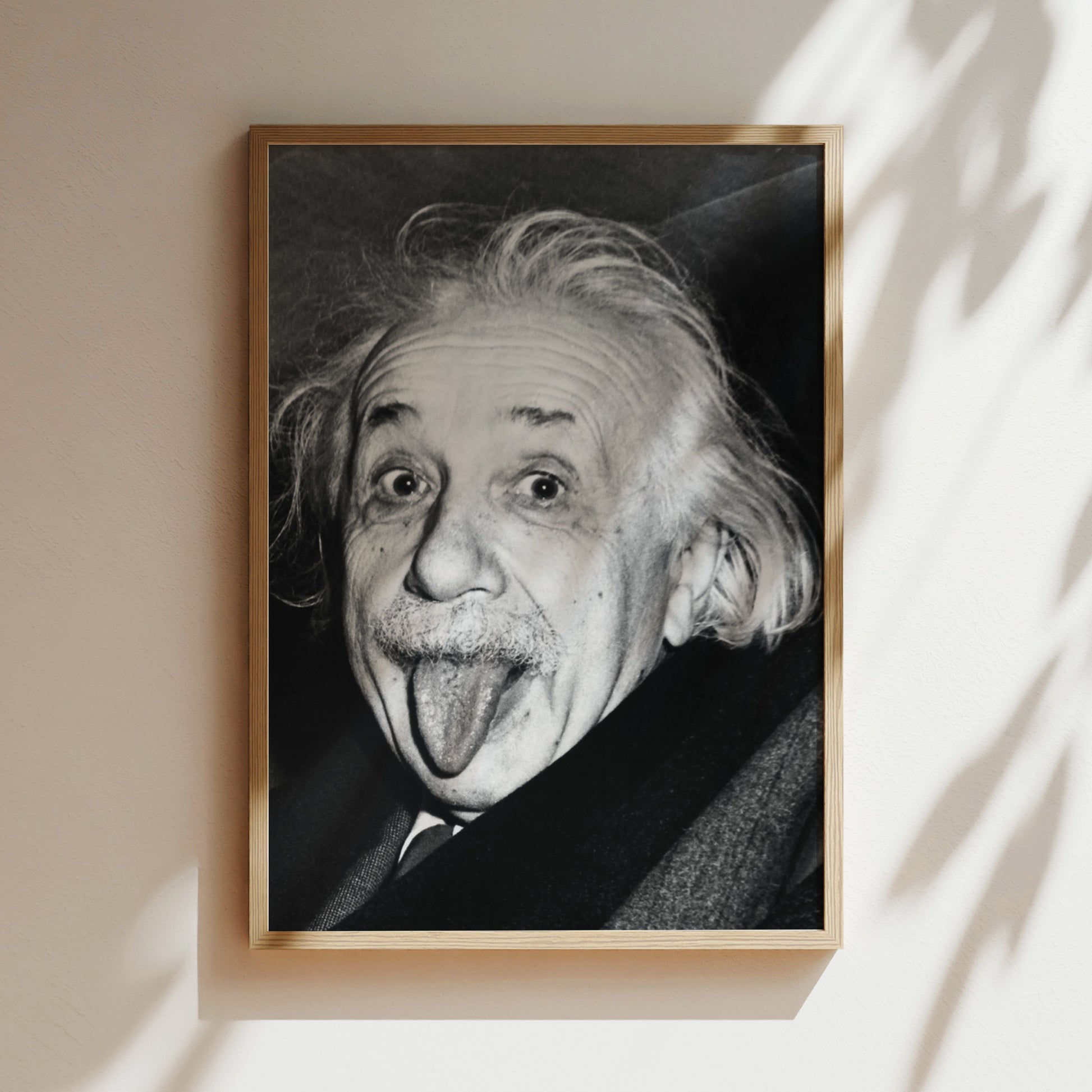 a black and white photo of an old man sticking his tongue out