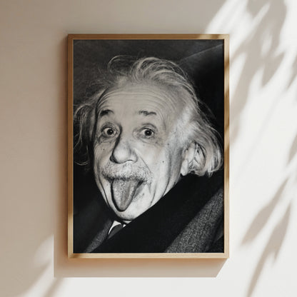 a black and white photo of an old man sticking his tongue out