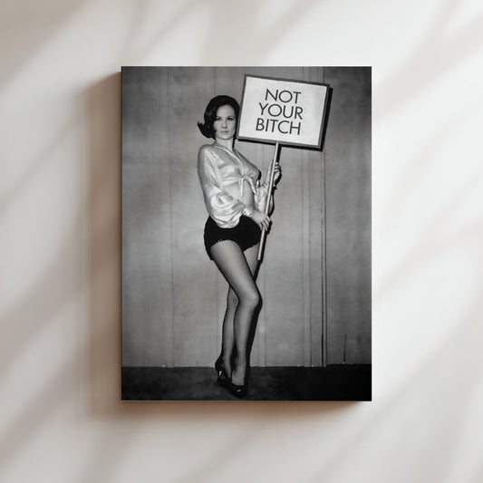 a black and white photo of a woman holding a sign