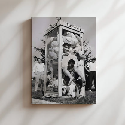 a black and white photo of a group of people in front of a telephone booth
