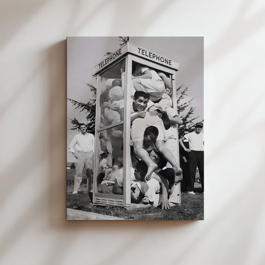 a black and white photo of a group of people in front of a telephone booth