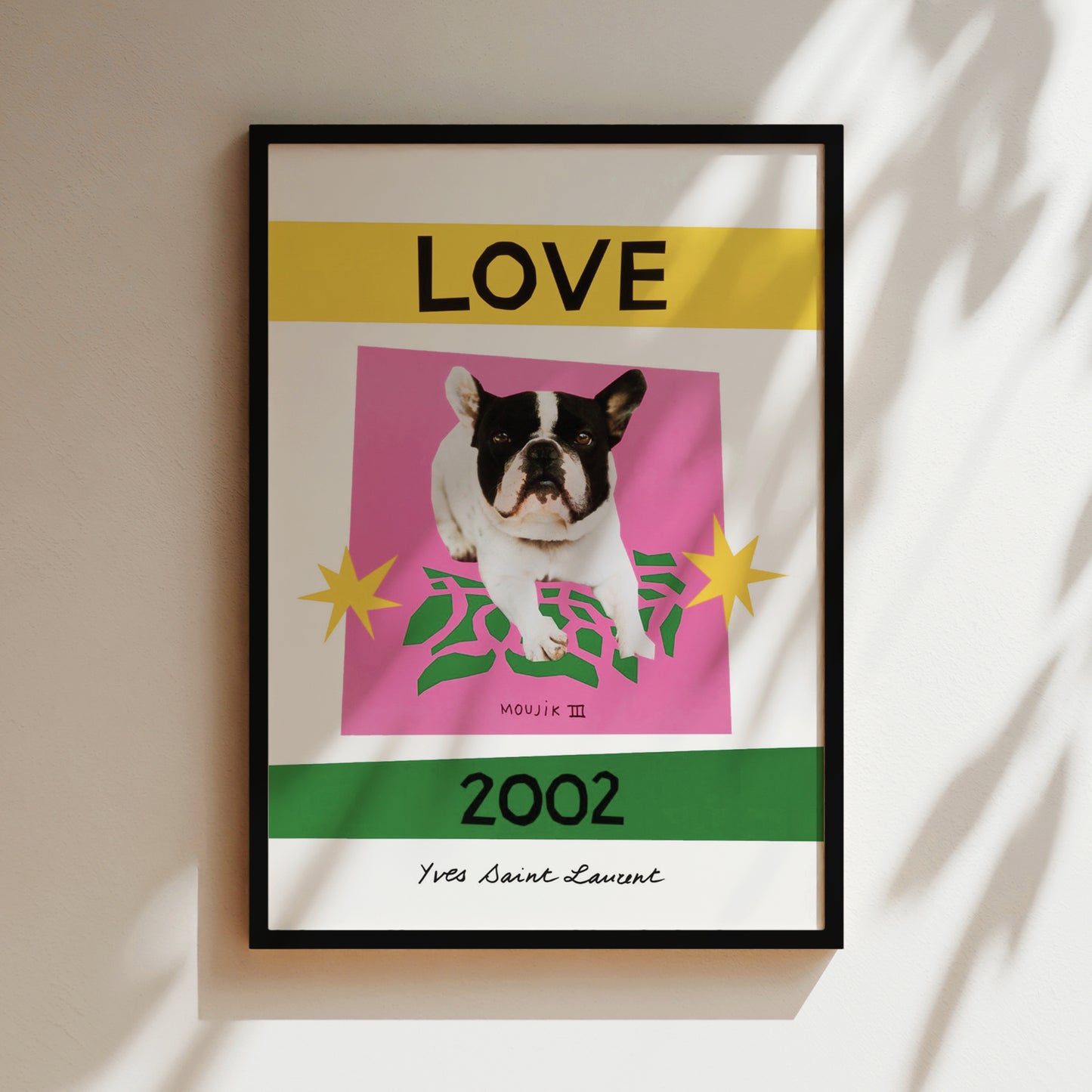 A framed poster with a black and white dog in the center, surrounded by a pink background with green leaves and yellow stars. The text "LOVE" is displayed above the dog, and "2002" is shown below it.