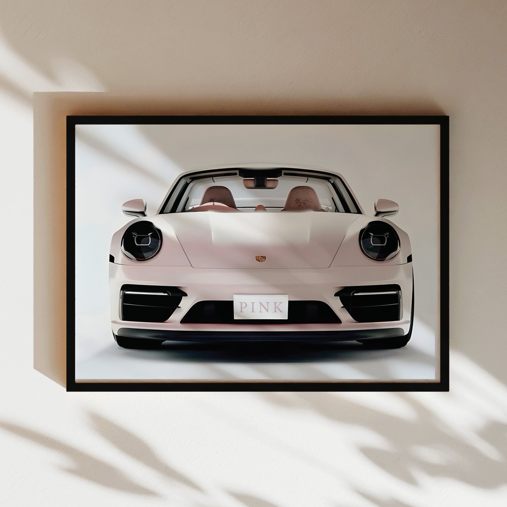 A framed image of a white Porsche 911 sports car with the word "PINK" displayed on the license plate.