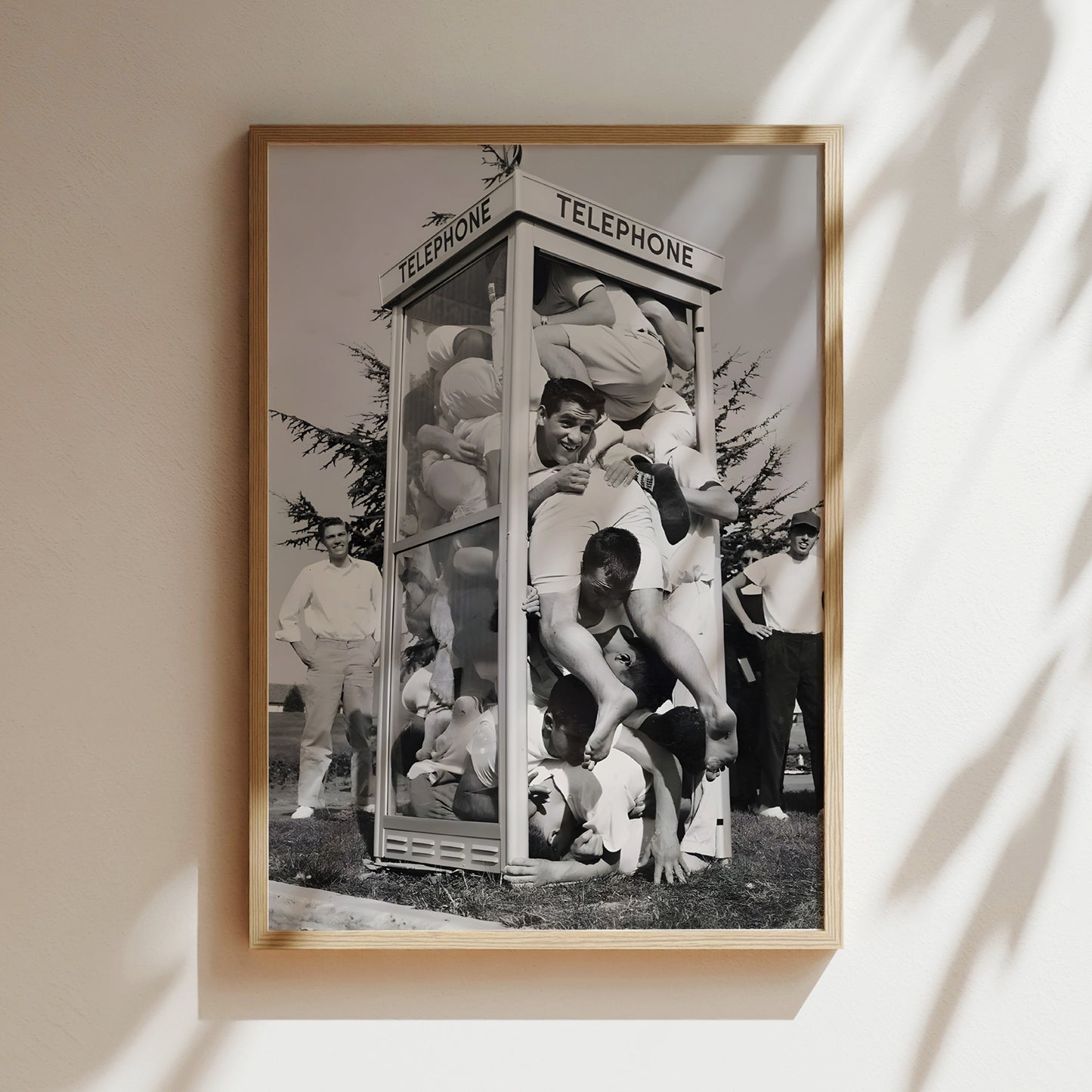 a black and white photo of a group of men in front of a telephone booth