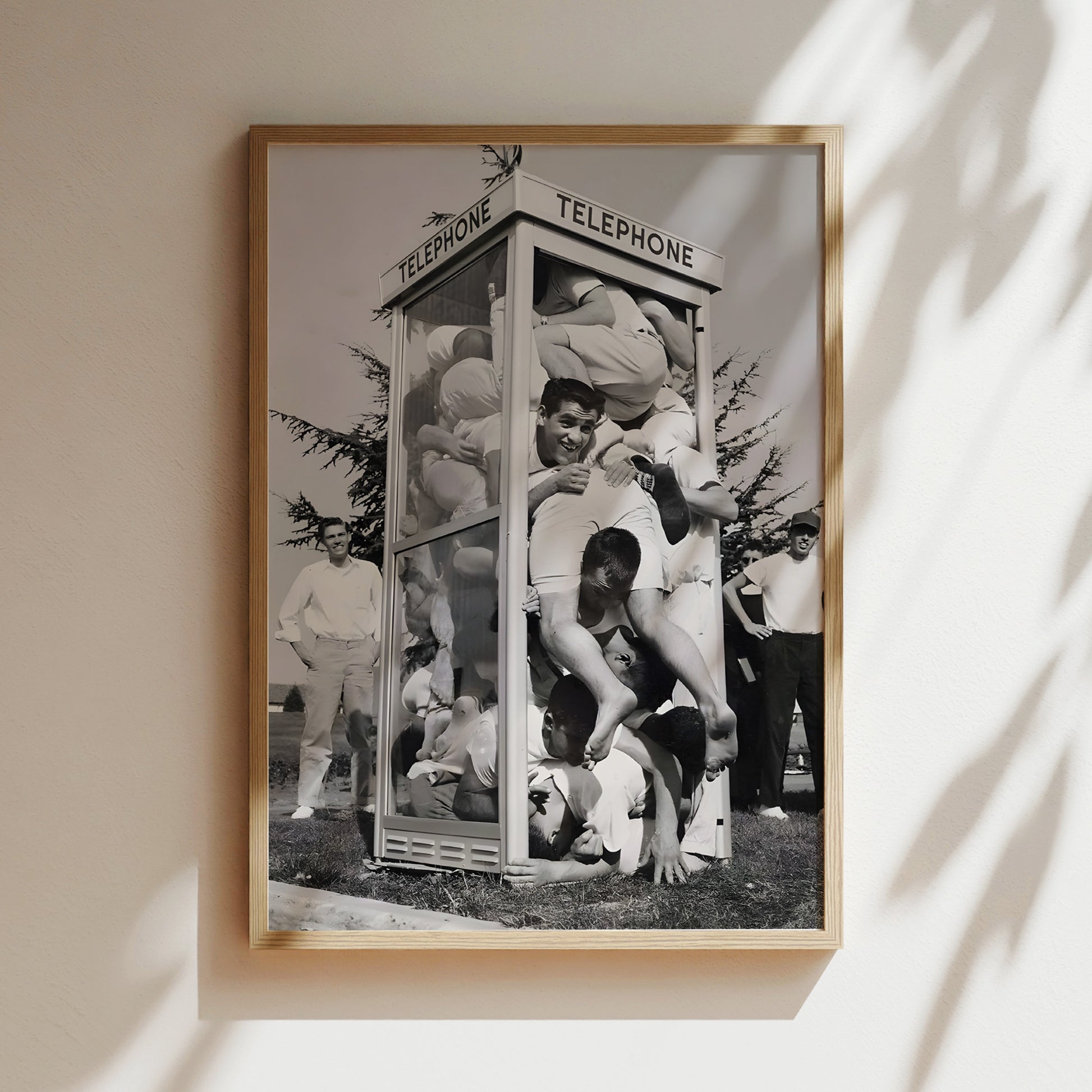 a black and white photo of a group of men in front of a telephone booth