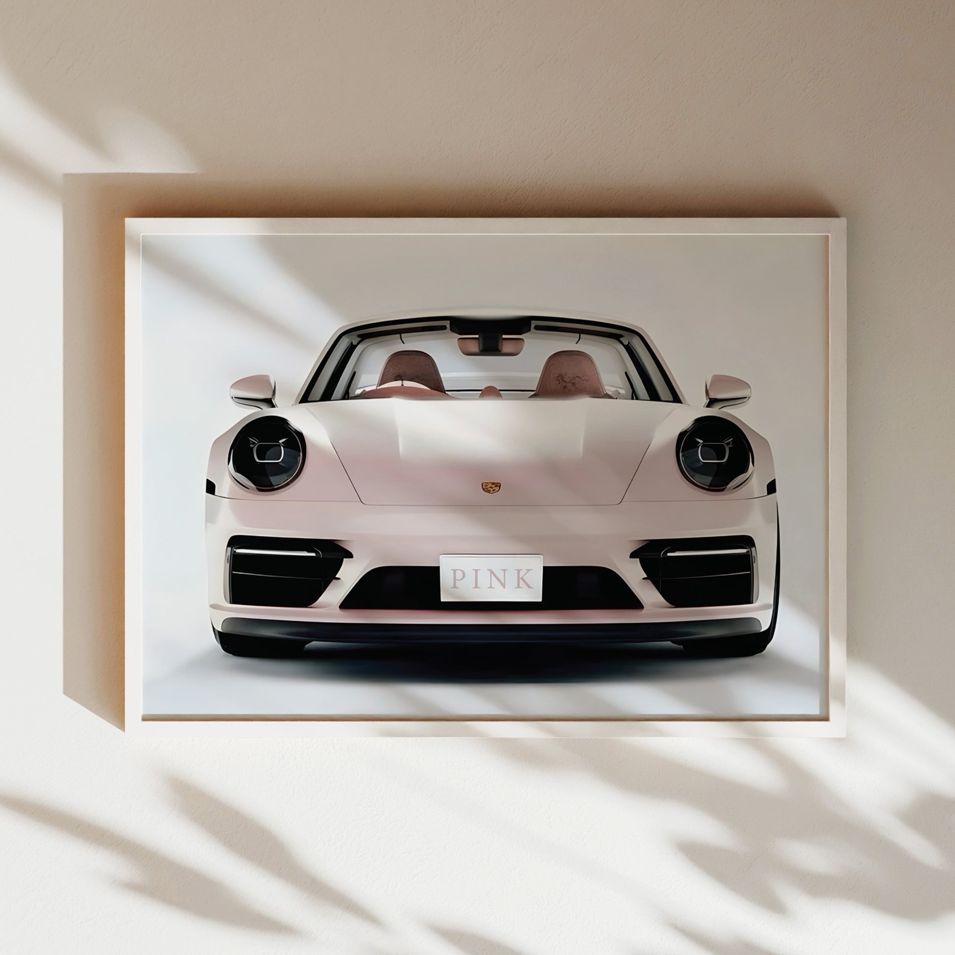 A framed image of a white Porsche 911 sports car with the word "PINK" displayed on the license plate.