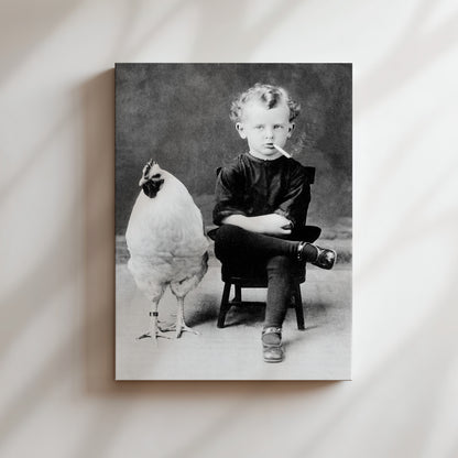 a black and white photo of a little boy sitting in a chair with a chicken