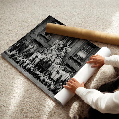 a young child is holding a rolled up photo
