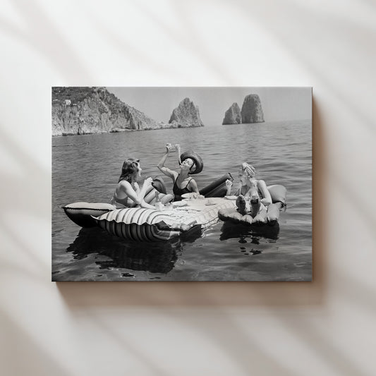 a black and white photo of a group of people on a beach