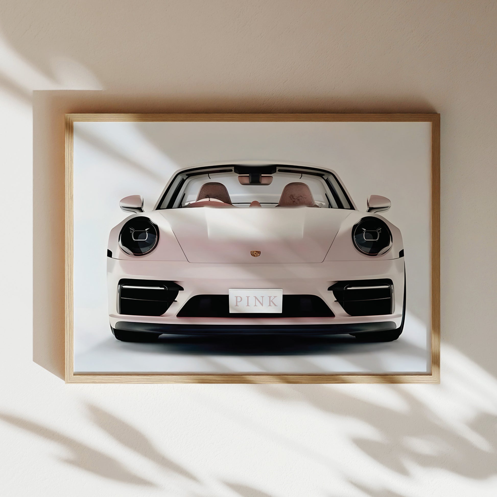 A framed image of a white Porsche 911 sports car with the word "PINK" displayed on the license plate.