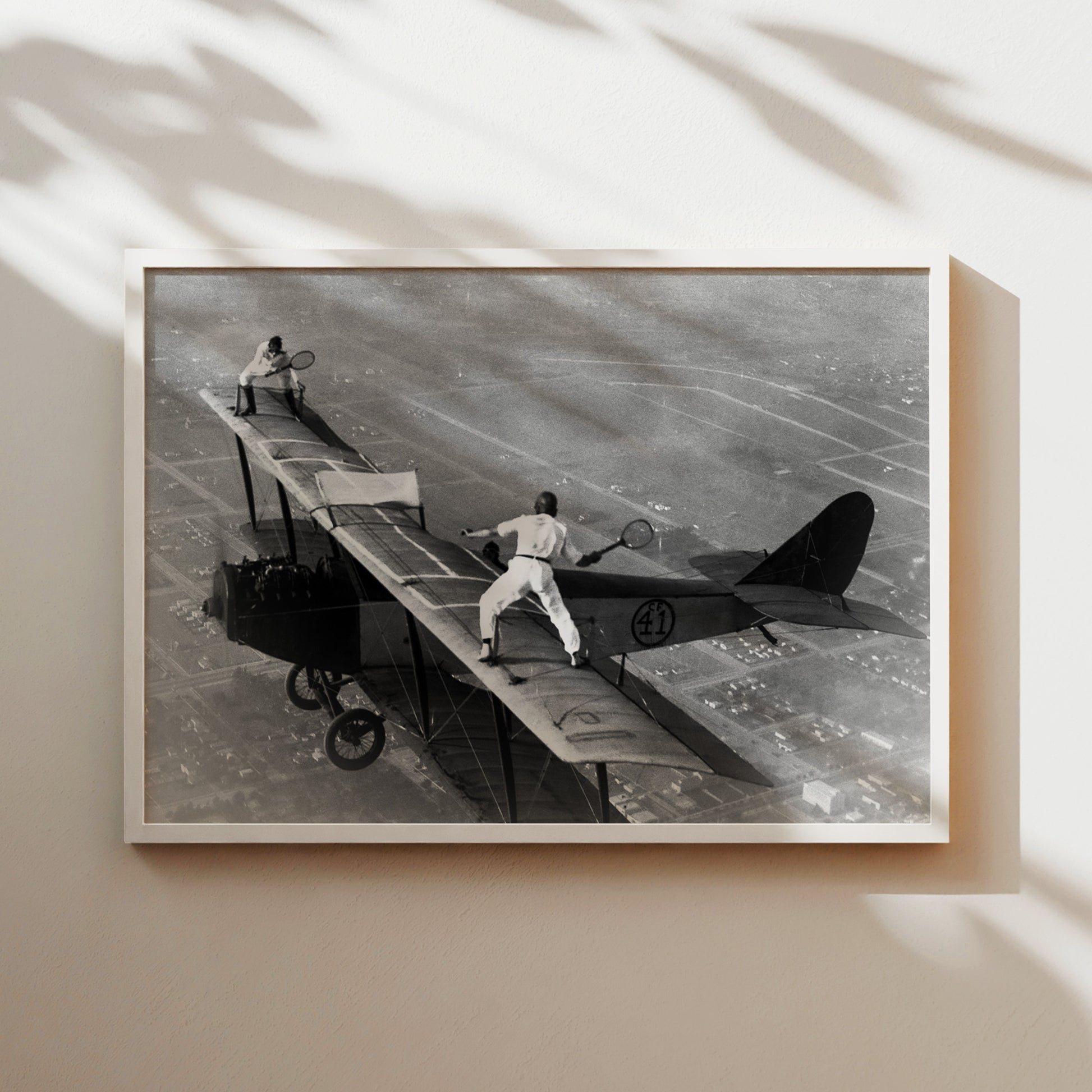a black and white photo of a man on a plane