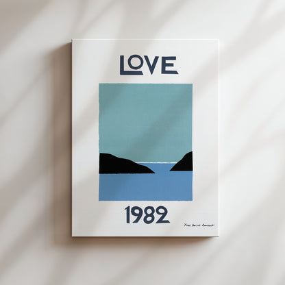 The image is a poster with a blue and black color scheme, featuring a landscape with mountains and a body of water. The text "LOVE" is prominently displayed at the top, and the year "1982" is shown at the bottom.