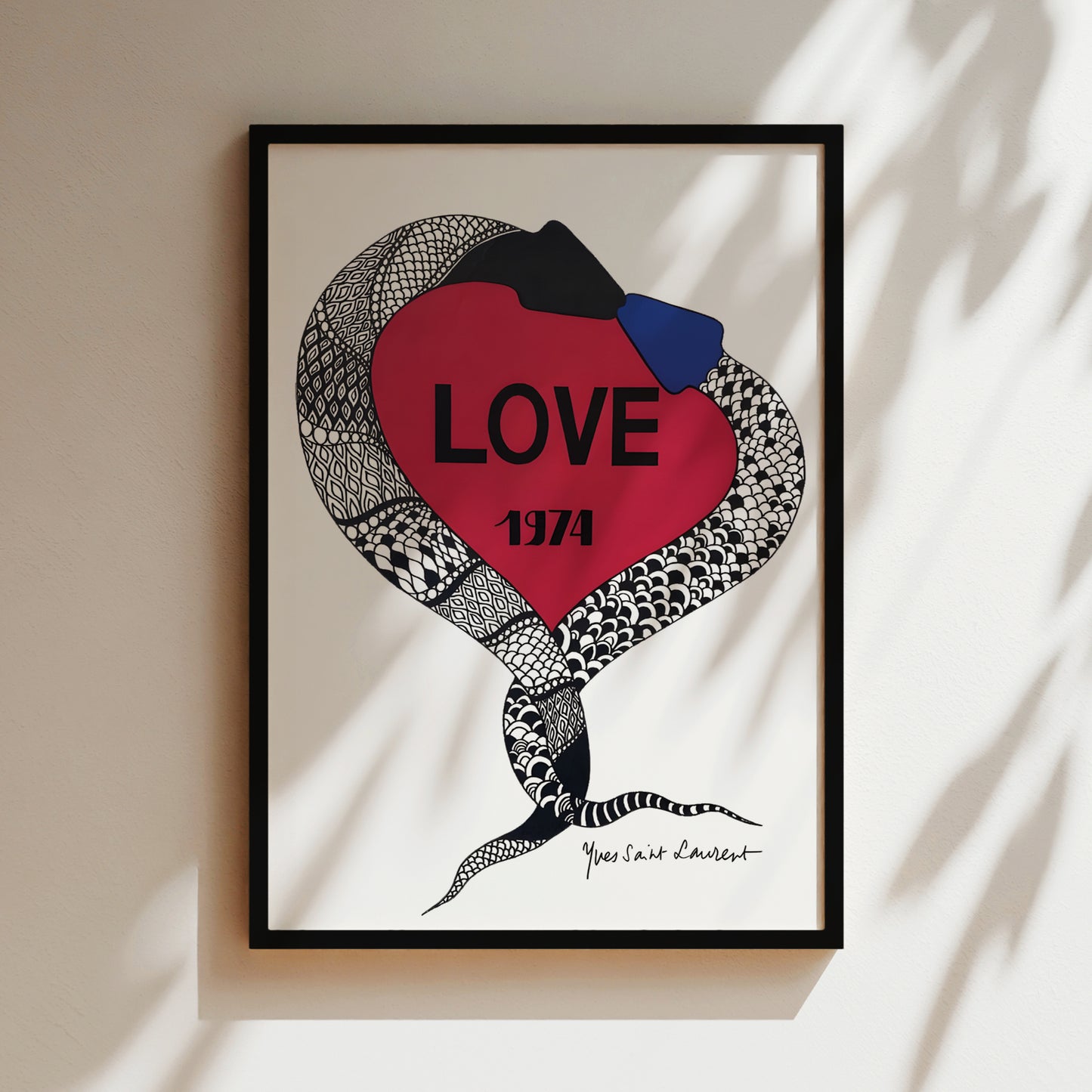 The image is a framed artwork featuring a red heart with a snake wrapped around it, and the word "LOVE" written inside the heart.