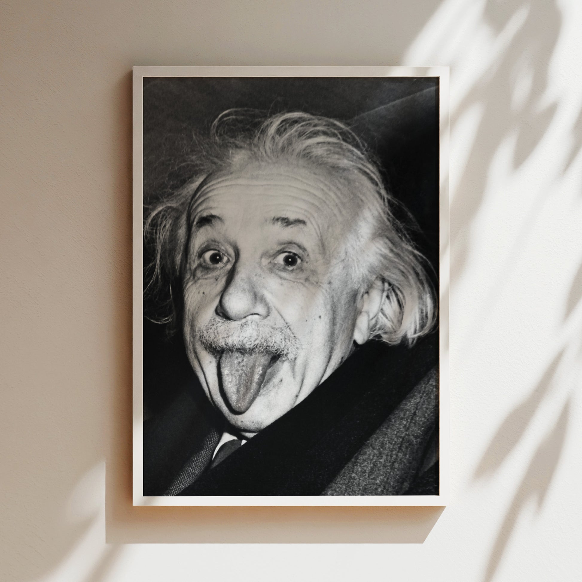 a black and white photo of an old man sticking his tongue out