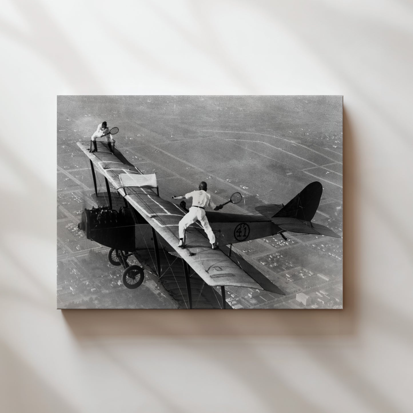 a black and white photo of a man on a plane