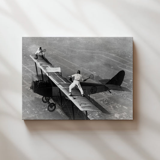 a black and white photo of a man on a plane