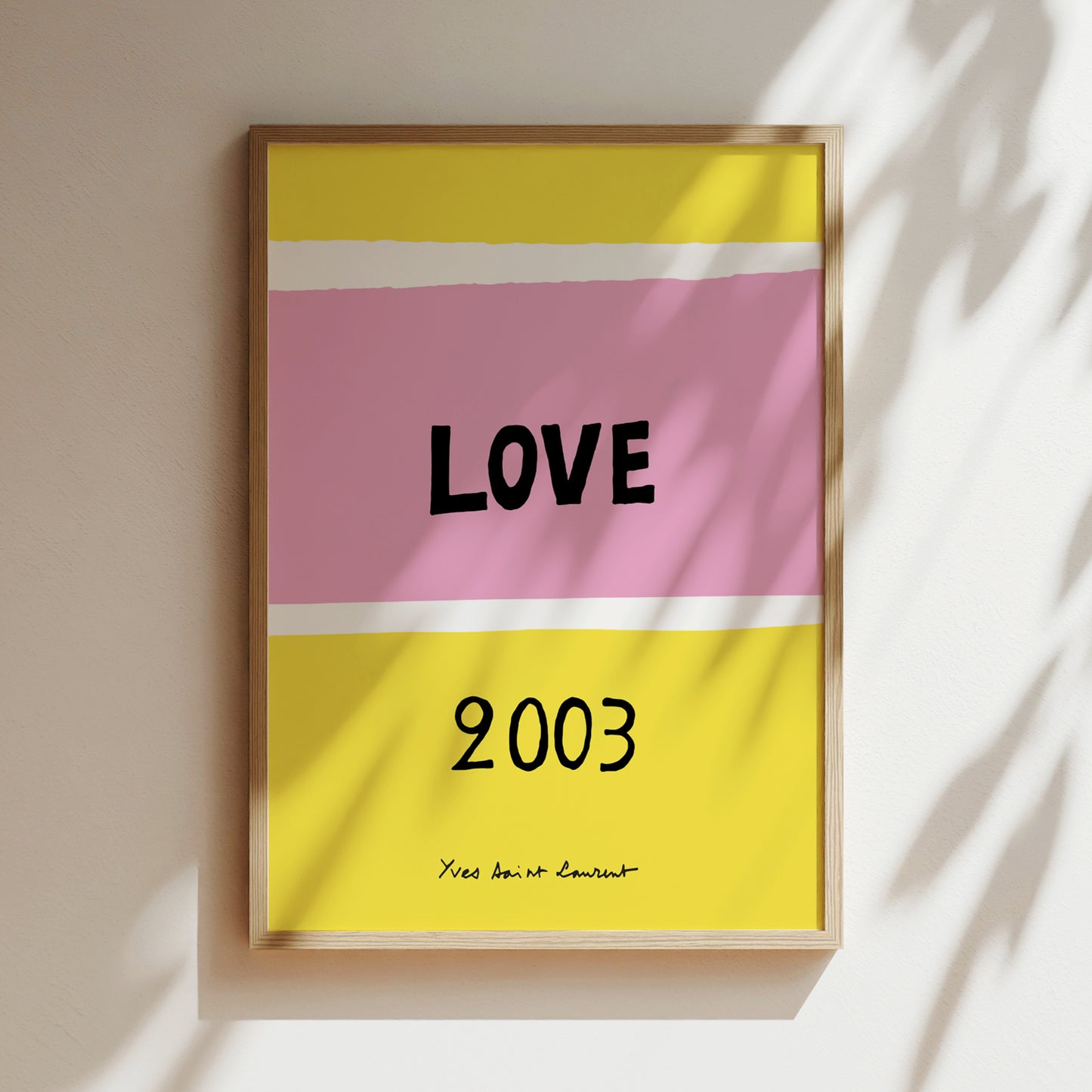 The image is a framed poster with a pink and yellow background, displaying the word "LOVE" in bold black letters. Below the word, the year "2003" is written in black.
