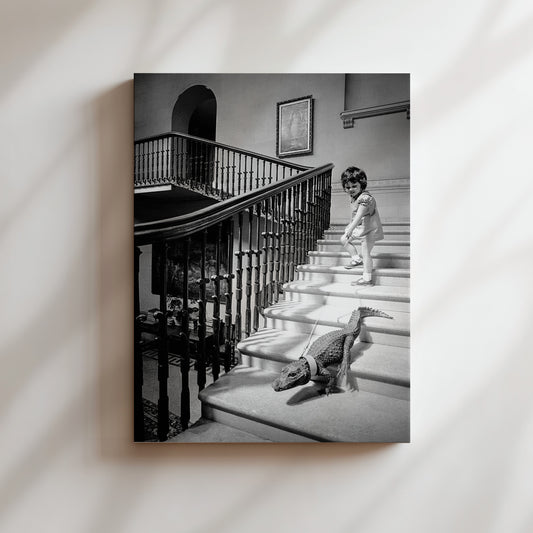 a black and white photo of a little girl walking down the stairs