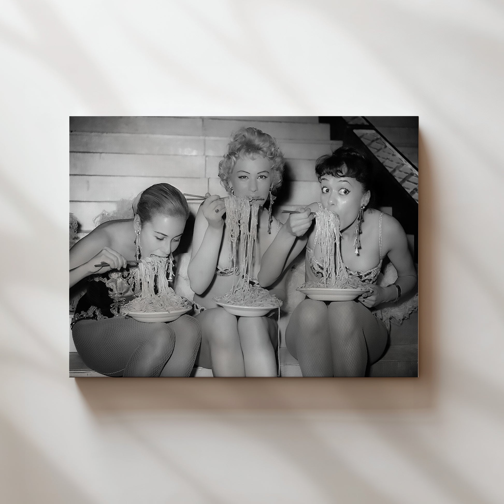 a black and white photo of three women in bathing suits