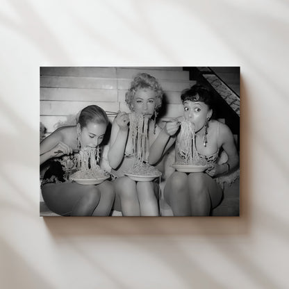 a black and white photo of three women in bathing suits