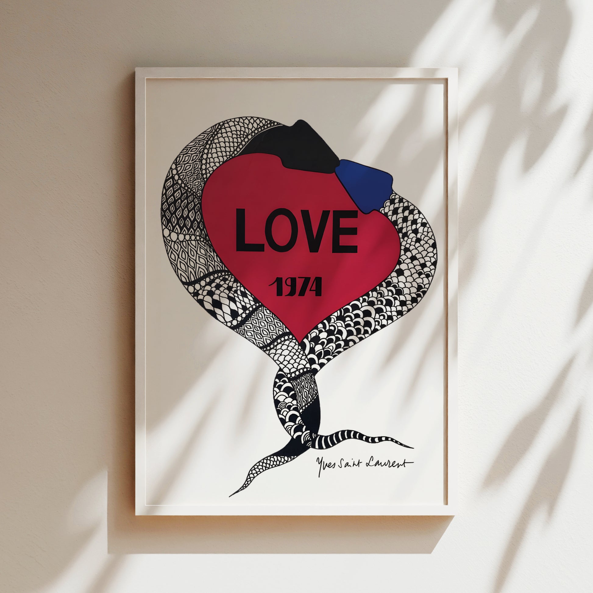 a framed artwork with a red heart-shaped design and a snake-like pattern. The word "LOVE" is prominently displayed in the center of the heart, and the year "1974" is written below it.