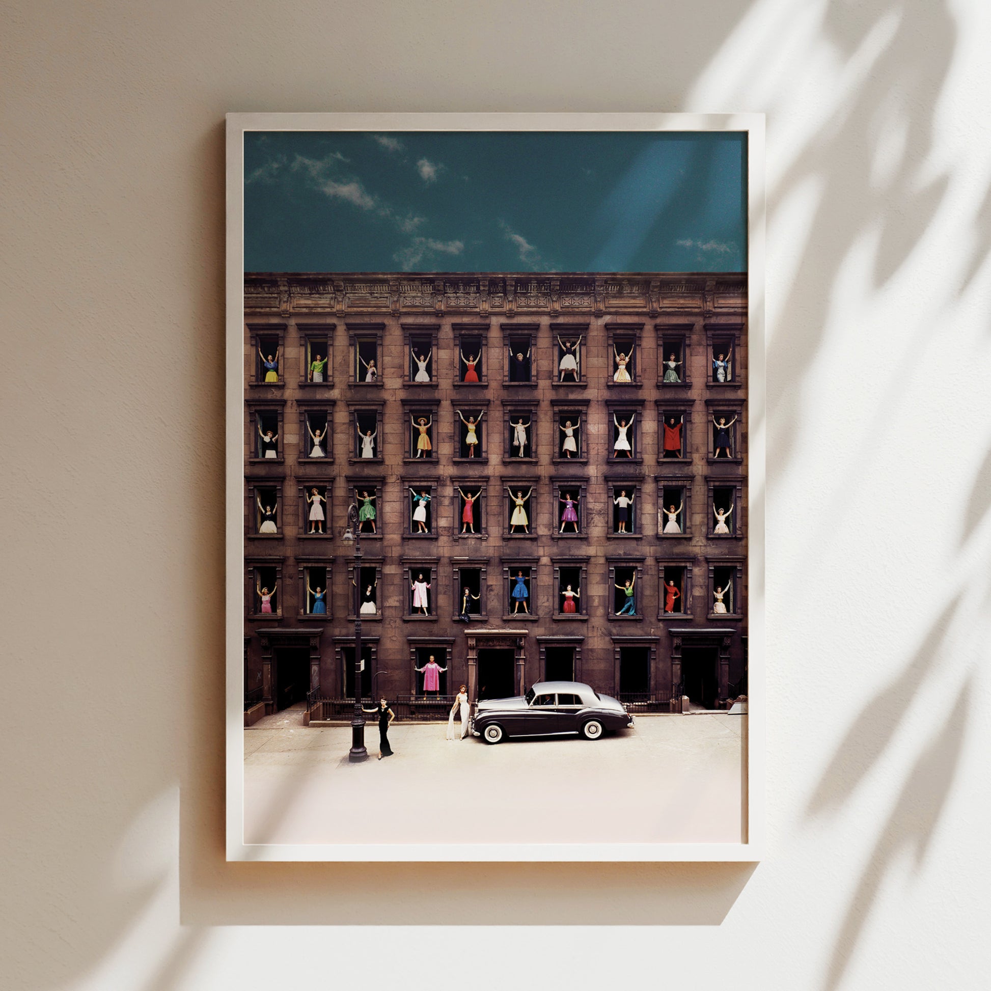 a black car parked in front of a tall building