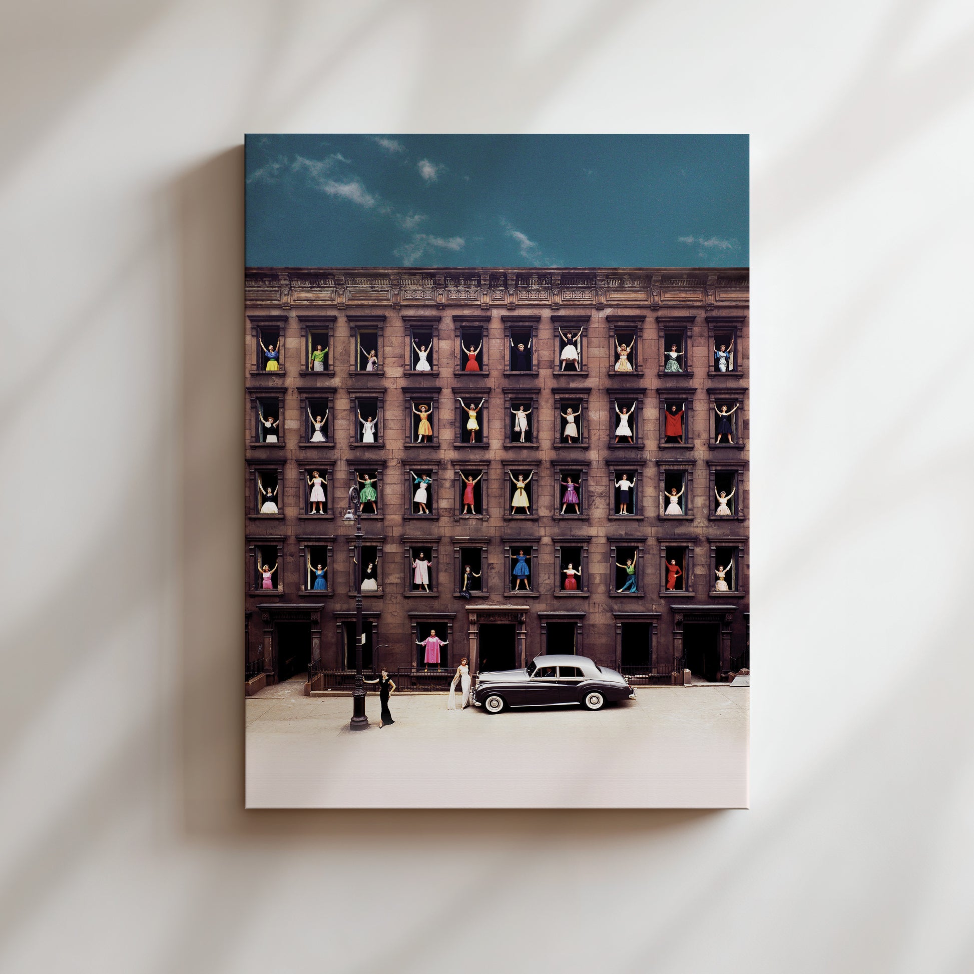 a black car parked in front of a tall building