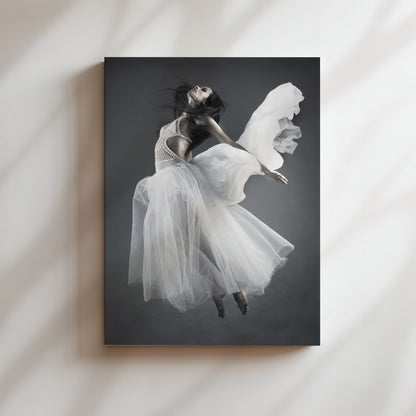 A woman in a flowing white dress is captured in mid-air, her arms outstretched, against a dark background.